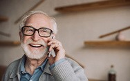 Senior man with glasses talking on phone