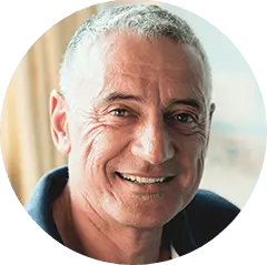 Smiling older man in dark blue shirt