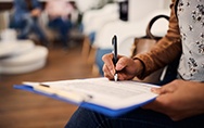 Woman filling out dental insurance form in lobby