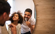 a father and child brushing their teeth in the morning