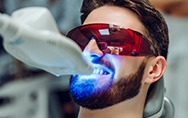 a man having his teeth whitened by a cosmetic dentist