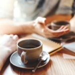 hands holding a cup of coffee 