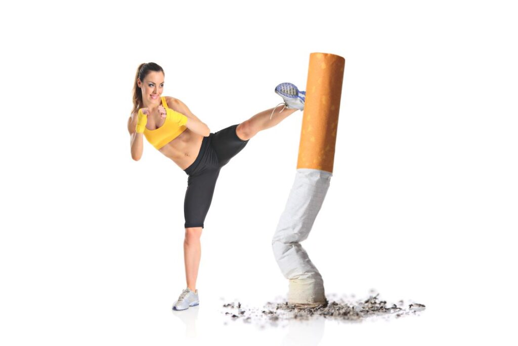 A woman kickboxing a giant cigarette.